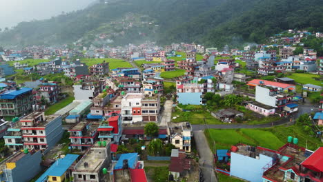 Aerial-flyover-residential-area-if-Pokhara-Town-with-colorful-houses-during-foggy-day-in-Nepal