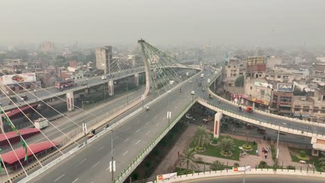 Aerial-drone-shot-over-traffic-movement-along-Azadi-bridge-in-Pakistan-during-morning-time