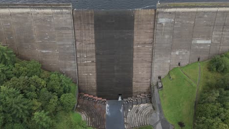 Booth-wood-reservoir-aerial-view-slowly-descending-the-concrete-dam-spillway-gate-in-West-Yorkshire