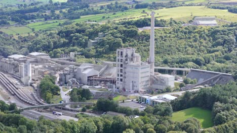 Hope-cement-works-aerial-view-circling-idyllic-rolling-countryside-in-Derbyshire-peak-district,-England