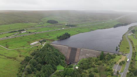 Booth-wood-reservoir-aerial-view-flying-over-the-lake-barrier-towards-M62-motorway-in-the-West-Yorkshire-countryside