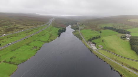 Booth-wood-reservoir-aerial-view-between-West-Yorkshire-M62-motorway-and-scenic-Blackwood-common-valley-countryside