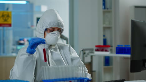 Neurologist-with-ppe-suit-working-at-vaccine-development-analysing-blood-sample
