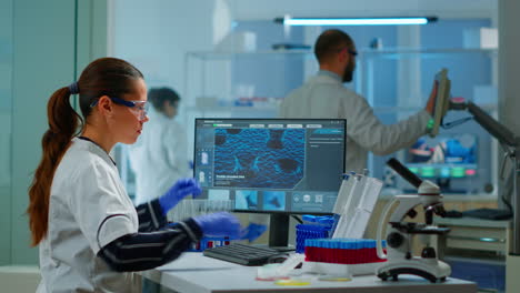 Chemistry-doctor-analysing-blood-sample-and-typing-on-computer