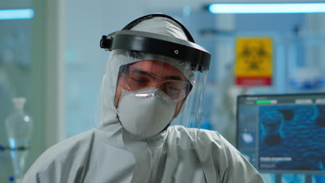 Close-up-of-tired-chemist-man-doctor-in-coverall-working-in-lab