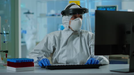 Laboratory-technician-assistant-in-ppe-suit-analyzing-blood-sample