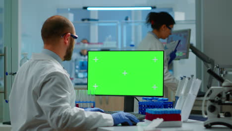 Researcher-looking-at-chroma-key-display-in-modern-equipped-lab