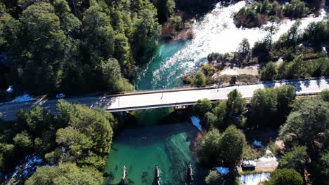 Countryside-road-bridge-over-majestic-river,-aerial-view