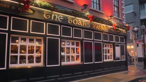 The-facade-of-the-Boars-head-pub-in-Dublin,-Ireland-is-decorated-for-Christmas