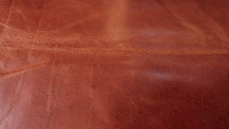 A-beautiful-rich-caramel-coloured-piece-of-leather-with-texture-and-patina-ready-to-be-used-to-create-leather-goods-in-a-small-artisan-workshop