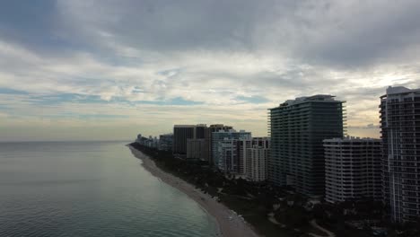 Aerial-Flyover-Along-The-Miami-Beach-Coastline-Revealing-Luxury-High-Rise-Buildings