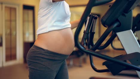 Active-pregnant-woman-exercise-in-fitness-center.