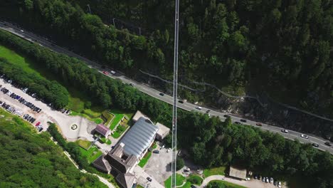 Aerial-view-of-people-walking-over-Highland-179-pedestrian-suspension-bridge-near-Ehrenberg-castle,-Reutte,-Germany