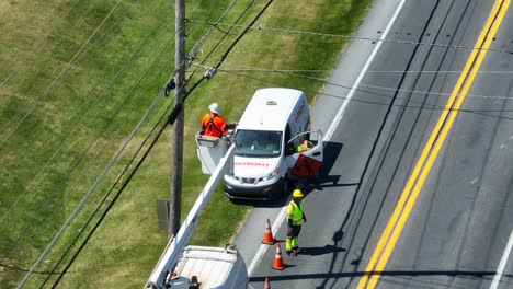 Utility-workers-fixing-power-lines-with-traffic-cones-for-safety