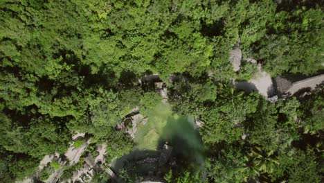 Bird-eye-ascending-aerial-view-over-Buuts'-Ha'-Cenote-Club,-enchanting-destination-nestled-in-the-heart-of-the-Yucatan-Peninsula,-Mexico,-offering-a-unique-and-immersive-experience