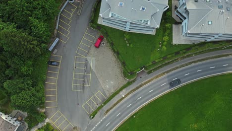 Cinematic-overhead-view-of-the-car-driving-on-empty-road-in-Swiss-village-road,-Sorenberg,-Switzerland