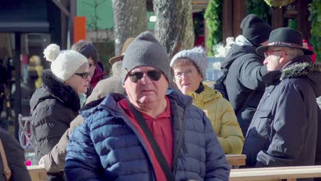 Elderly-couples-talking-at-Christmas-market-in-Sterzing,-South-Tyrol,-Italy