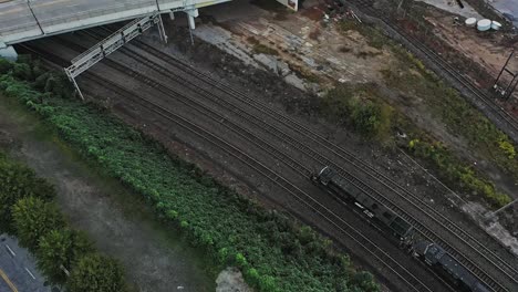 Aerial-top-down-shot-of-industrial-railway-slowly-on-tracks-in-suburb-area-of-Atlanta-City