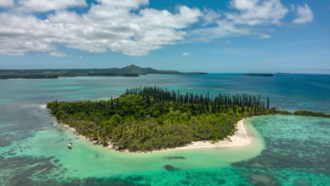 Boats-take-tourists-to-Ile-Moro-in-New-Caledonia---uninhabited-island-paradise-aerial-orbit-hyper-lapse