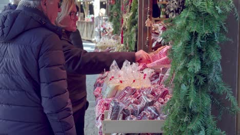 Visitors-to-the-Christmas-market-point-and-examine-the-goods-on-display