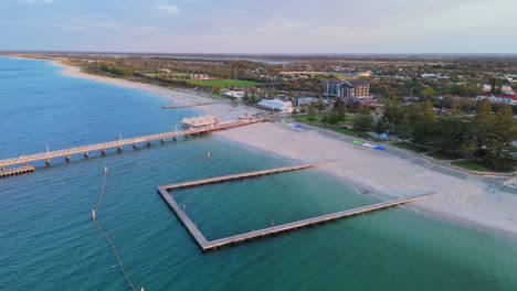 Sunset-over-Busselton-Jetty-ocean-pool-as-drone-pans-slowly-around