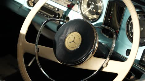 Vintage-Mercedes-steering-wheel-and-interior-with-baby-blue,-cream-and-chrome-details