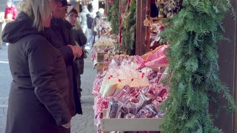 Visitors-to-the-Christmas-market-point-and-examine-the-goods-on-display