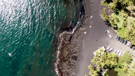 Drop-down-aerial-Punaluʻu-Beach,-Big-Island,-Hawaii,-USA-drone-view