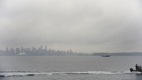 Vancouver-City-Skyline,-cloaked-in-a-melancholic-overcast,-with-the-distant-silhouette-of-the-Sea-Bus
