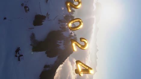 Bright-Switzerland-mountain-aerial-view-with-golden-2024-new-year-numbers