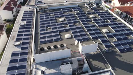 Solar-panels-on-a-supermarket,-renewable-green-energy,-production-of-electricity,-aerial