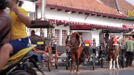 Row-of-horse-drawn-carriages-on-the-roadside-of-Malioboro-Street,-Yogyakarta---Ambience-of-Malioboro-Street
