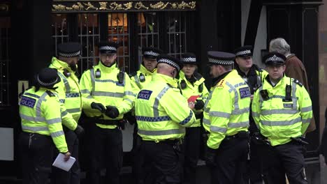 MET-police-officers-gather-outside-the-Royal-Courts-of-Justice-in-London,-UK