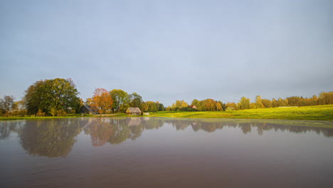 Autumn-to-Winter-time-lapse-of-weather-changing-at-a-countryside-home-by-a-lake
