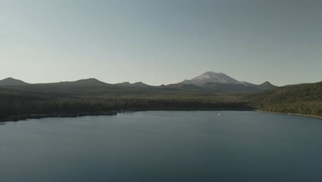 Wide-aerial-view-of-Elk-Lake-in-Oregon-with-Mount-Bachelor-looming-in-the-distance