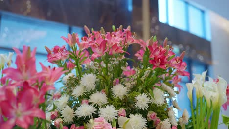 pink-and-white-flowers-decoration-at-the-entrance-of-hotel-close-up-shot,-Arc-shot,-low-angle-shot