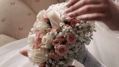 Bride-holding-a-bouquet-of-pink-and-white-roses
