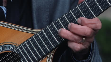 Fingers-plucking-a-traditional-Portuguese-guitar.-close-up