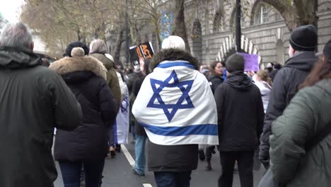 Jewish-protester-walks-besides-the-river-Thames-on-a-rally-against-antisemitism-in-London,-UK