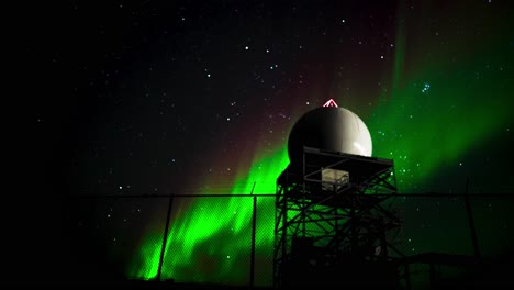 Northern-lights-behind-tower-in-arctic-tundra