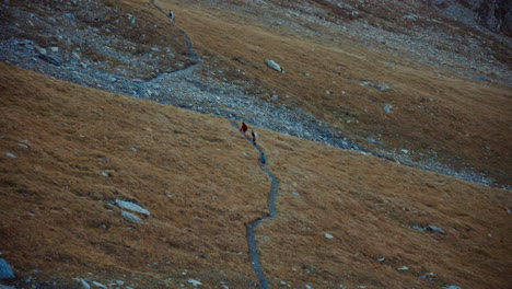 Tourists-Hikers-Walking-Along-Mountainous-Trail-in-Italian-Alps-Region-in-Autumn-Season