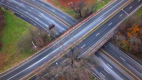 An-aerial-time-lapse-over-a-highway-intersection-on-Long-Island,-New-York-on-a-cloudy-day