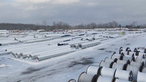 Snow-Covered-Rural-Construction-Supply-Yard,-Aerial