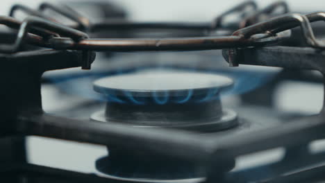 Close-up-of-a-gas-stove-burner-with-a-blue-flame
