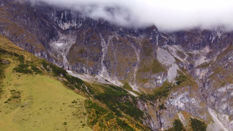 Mountain-slope,-clouds-covered-peaks-in-Hochkonig,-Austria,-aerial-view