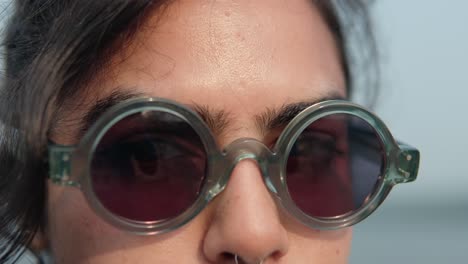 Close-up-of-a-woman-with-glasses-looking-into-the-camera