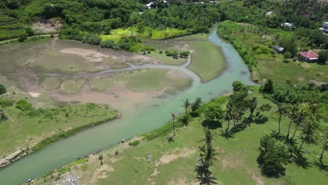 A-small-turquoise-river-near-the-coast-in-Lombok,-Indonesia