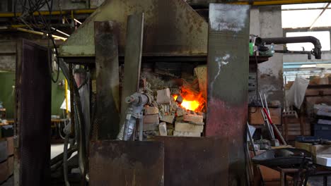High-temperature-flames-coming-out-of-Murano-glass-furnace,-Italy