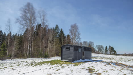 Time-lapse-of-a-modern-hut,-weather-and-seasons-changing-on-the-countryside