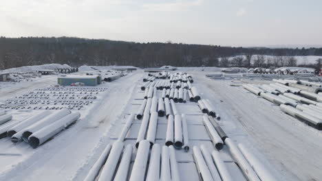 Snow-Covered-Construction-Materials-Supply-Yard-in-the-Winter,-Aerial